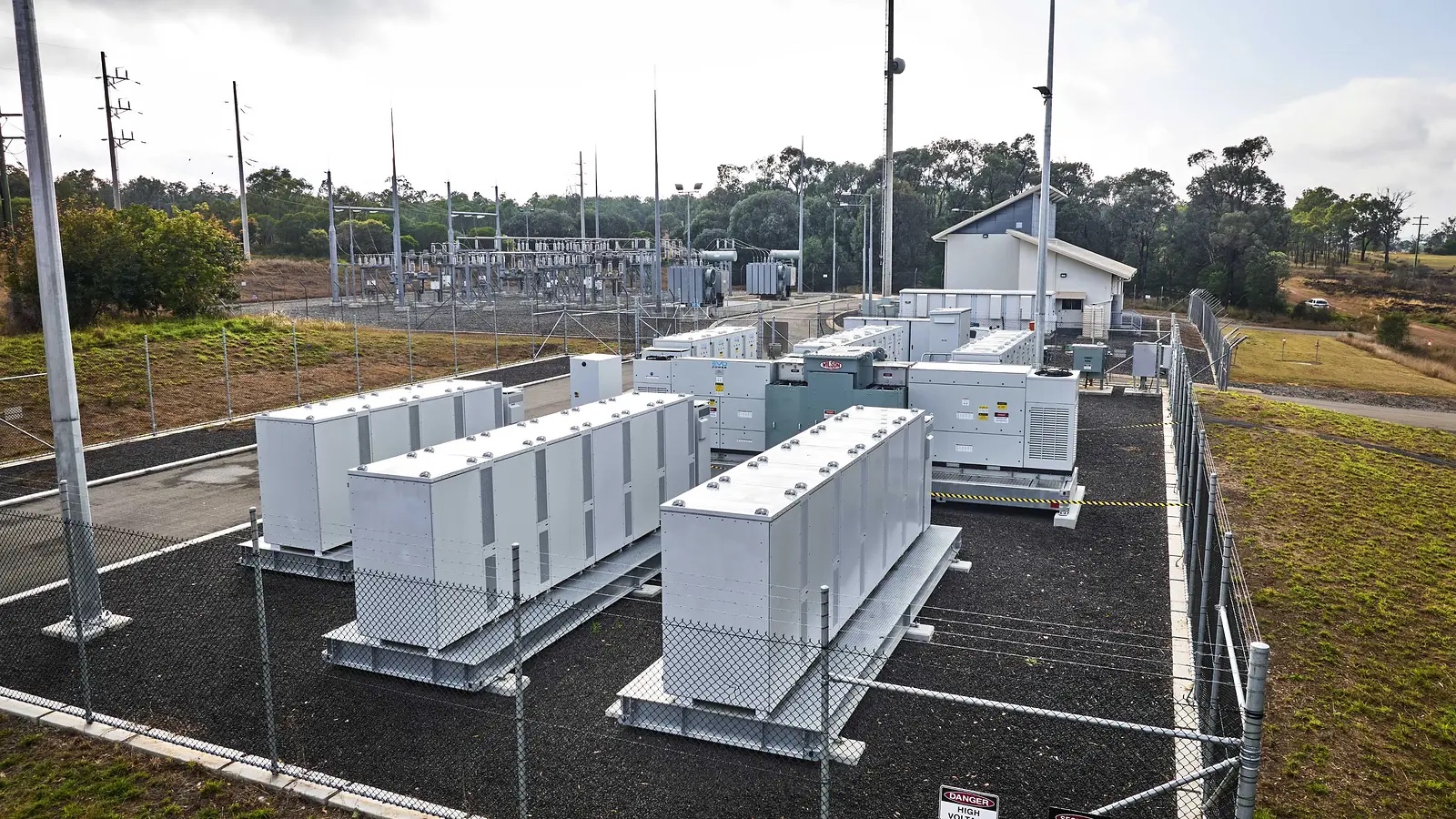 Battery Energy System cabinets and switchgear beside a substation